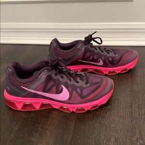 Pink and purple pair of Nike running shoes